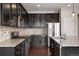 Modern kitchen featuring stainless steel appliances, granite countertops, and ample cabinet space at 1523 Honeysuckle Ct, Brighton, CO 80601