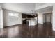 Open concept kitchen with dark cabinets and hardwood floors at 1523 Honeysuckle Ct, Brighton, CO 80601