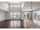 Bright living room with high ceilings, dark hardwood floors and big windows at 1523 Honeysuckle Ct, Brighton, CO 80601