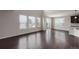 Bright living room boasts large windows, high ceilings, and beautiful hardwood floors at 1523 Honeysuckle Ct, Brighton, CO 80601