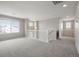 Open loft area with neutral carpeting, natural light, and versatile space at 1523 Honeysuckle Ct, Brighton, CO 80601
