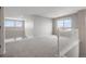 Bright loft area with neutral carpet and staircase, perfect for a playroom or second living area at 1523 Honeysuckle Ct, Brighton, CO 80601