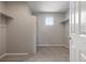 Spacious walk-in closet with carpeted floors, shelving and a window for natural lighting at 1523 Honeysuckle Ct, Brighton, CO 80601