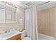 Well-lit bathroom with a vanity, mirror, and a shower-tub combination with a curtain at 9110 E Girard Ave # 1, Denver, CO 80231