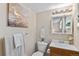 Compact bathroom featuring a vanity with wood cabinets, a mirror, and decorative accents at 9110 E Girard Ave # 1, Denver, CO 80231