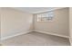 Inviting bedroom featuring neutral walls, plush carpeting, and a bright window at 9110 E Girard Ave # 1, Denver, CO 80231