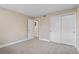 Spacious bedroom with neutral carpet, a large closet, and access to the hallway at 9110 E Girard Ave # 1, Denver, CO 80231