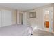Neutral carpeted bedroom with view into ensuite bathroom with wood vanity at 9110 E Girard Ave # 1, Denver, CO 80231