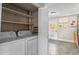 Convenient laundry area with shelving and a nearby doorway leading to additional space at 9110 E Girard Ave # 1, Denver, CO 80231