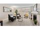 Living room featuring a brick fireplace, large window, neutral paint and carpet at 9110 E Girard Ave # 1, Denver, CO 80231