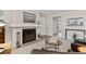 Living room featuring a brick fireplace, large window, neutral paint and carpet at 9110 E Girard Ave # 1, Denver, CO 80231