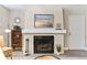 Living room featuring a brick fireplace, large window, neutral paint and carpet at 9110 E Girard Ave # 1, Denver, CO 80231