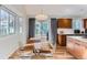 Dining area with modern lighting, wood table, and direct access to the kitchen and backyard at 4861 Curie Ct, Boulder, CO 80301