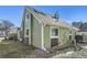Green house exterior with deck and landscaping at 4861 Curie Ct, Boulder, CO 80301