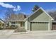 Charming home with an attached garage, landscaped front yard, and classic curb appeal at 4861 Curie Ct, Boulder, CO 80301