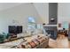 Open living room with fireplace, hardwood floors and kitchen view at 4861 Curie Ct, Boulder, CO 80301
