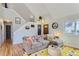 Living room with vaulted ceilings, hardwood floors, and a cozy couch at 4861 Curie Ct, Boulder, CO 80301