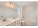 Bright bathroom featuring double sinks, quartz counters, and a tub and shower combo at 13832 Honey Hush Trl, Parker, CO 80134