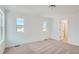 Spacious bedroom with plush carpeting, bright windows, and an ensuite bathroom entrance at 13832 Honey Hush Trl, Parker, CO 80134