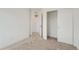 Spare bedroom featuring neutral carpeting, white walls, and a closet with shelving at 13832 Honey Hush Trl, Parker, CO 80134