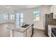 Gourmet kitchen featuring granite island with stainless steel sink and modern appliances at 13832 Honey Hush Trl, Parker, CO 80134