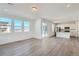Bright, open-concept living space with hardwood floors, recessed lighting, and large windows with great views at 13832 Honey Hush Trl, Parker, CO 80134