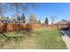 Well-maintained backyard featuring a lush lawn and a wood fence for added privacy at 6719 W 70Th Ave, Arvada, CO 80003