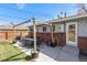 Inviting backyard featuring a patio with outdoor dining, a pergola, and a grassy area at 6719 W 70Th Ave, Arvada, CO 80003