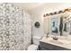 Well-lit bathroom features a geometric shower curtain and a modern vanity at 6719 W 70Th Ave, Arvada, CO 80003