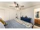 Comfortable bedroom featuring a bed, blue dresser, and ensuite bathroom entrance at 6719 W 70Th Ave, Arvada, CO 80003