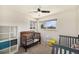 Bright bedroom with two cribs, natural light, and ample space at 6719 W 70Th Ave, Arvada, CO 80003