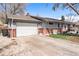 Charming single-story home featuring a garage, and a well-maintained front yard at 6719 W 70Th Ave, Arvada, CO 80003