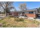 Charming single-story home featuring a well-manicured front yard and solar panels at 6719 W 70Th Ave, Arvada, CO 80003