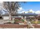 Charming ranch-style home with brick accents, solar panels, a well-kept yard, and mature landscaping at 6719 W 70Th Ave, Arvada, CO 80003