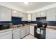 Functional kitchen with updated appliances, ample counter space, and stylish backsplash at 6719 W 70Th Ave, Arvada, CO 80003