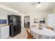 Kitchen with tile floors, a black refrigerator, and adjacent spaces at 6719 W 70Th Ave, Arvada, CO 80003