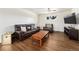 Comfortable living room showcasing hardwood floors, a plush leather sofa, and a central coffee table at 6719 W 70Th Ave, Arvada, CO 80003