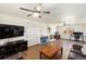 Spacious living room features hardwood floors, ceiling fan, and a cozy fireplace at 6719 W 70Th Ave, Arvada, CO 80003