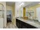 Modern bathroom with double sinks, granite counters, walk-in shower, and large walk-in closet at 15222 E Batavia Pl, Aurora, CO 80011