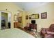 View of primary bedroom with hardwood floors, sitting area, and ensuite bath at 15222 E Batavia Pl, Aurora, CO 80011