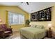 Primary bedroom with hardwood floors, ceiling fan, and large window providing natural light at 15222 E Batavia Pl, Aurora, CO 80011