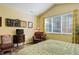 Primary bedroom with hardwood floors, vaulted ceiling, and large window providing natural light at 15222 E Batavia Pl, Aurora, CO 80011