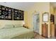 Primary bedroom with ensuite bathroom, hardwood floors, and vaulted ceilings at 15222 E Batavia Pl, Aurora, CO 80011