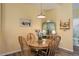 Dining room features a wooden table, four chairs, hardwood floors, and adjacent bathroom at 15222 E Batavia Pl, Aurora, CO 80011
