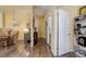 Hallway leading to bathroom and dining area with wood flooring at 15222 E Batavia Pl, Aurora, CO 80011