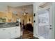 View of kitchen with granite counters, hardwood floors, and stainless appliances adjacent to the living room at 15222 E Batavia Pl, Aurora, CO 80011