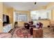Cozy living room with plush leather chairs and large windows overlooking backyard at 15222 E Batavia Pl, Aurora, CO 80011