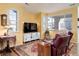 Bright living room with a large TV, windows and comfortable seating at 15222 E Batavia Pl, Aurora, CO 80011