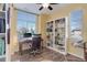 Bright office space featuring a built-in bookcase and large window at 15222 E Batavia Pl, Aurora, CO 80011