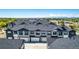 Wide aerial view of townhome community surrounded by greenery and distant mountains at 157 Ambrose St, Erie, CO 80516